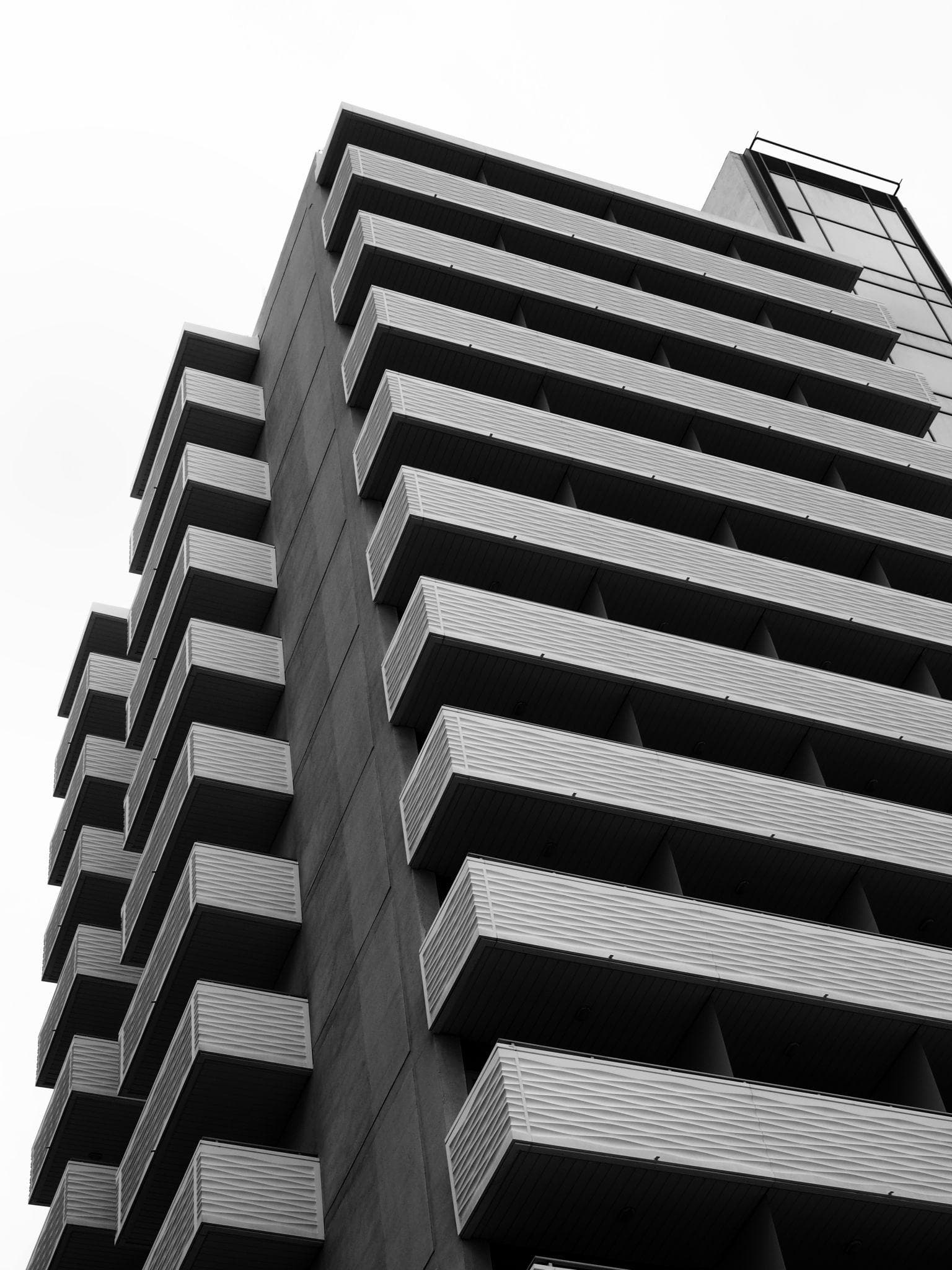 Editorial black and white tower facade representing institutional real estate strategy